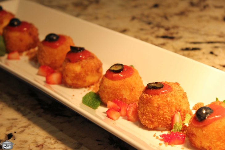 Warm cheesecake pops with a strawberry basil pulse.