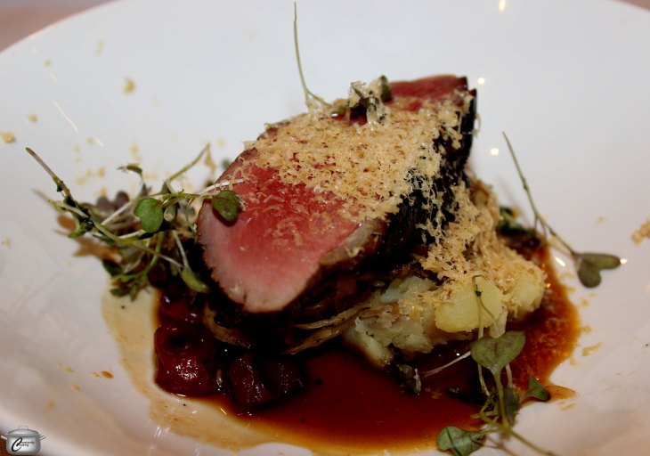 Roasted garlic potatoes, choucroute garnis with pulled duck leg and wild mustard, topped with smoked duck breast, shaved fois gras and sour cherry and duck jus.