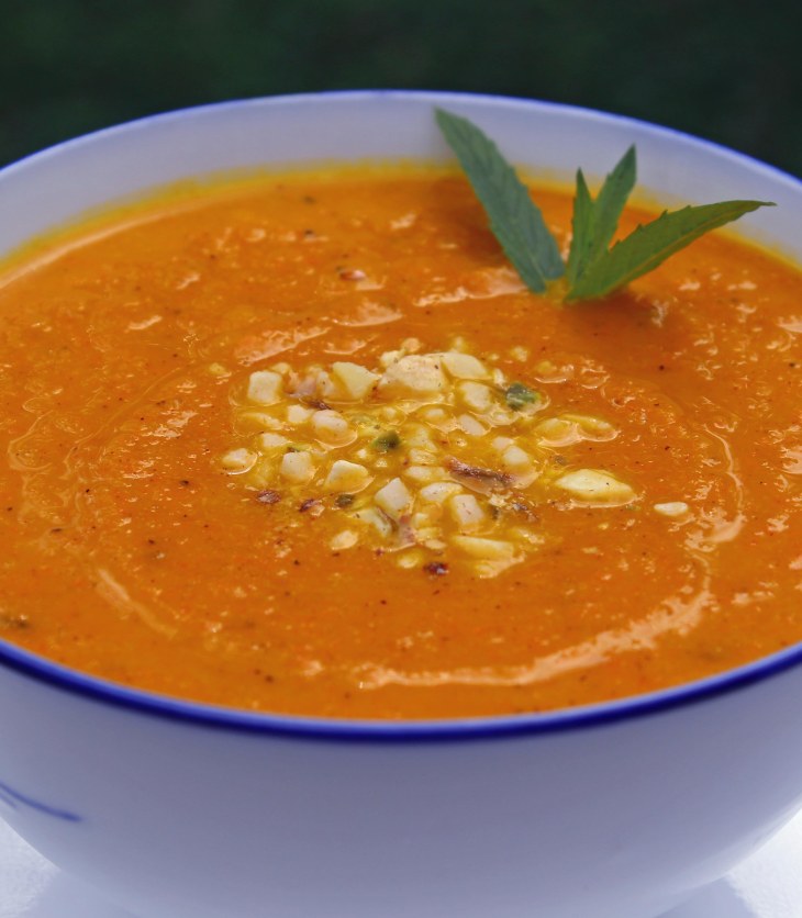 carrot soup flavoured with ras el hanout and garnished with mint and dukkah