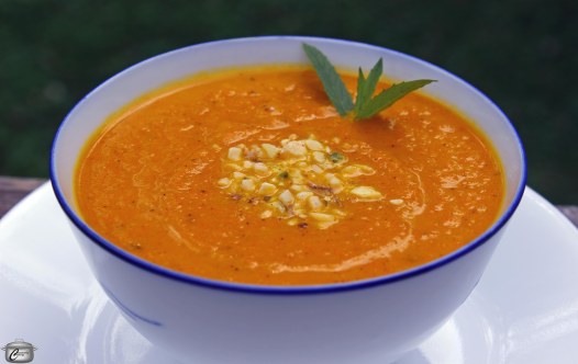 carrot soup flavoured with ras el hanout and garnished with mint and dukkah