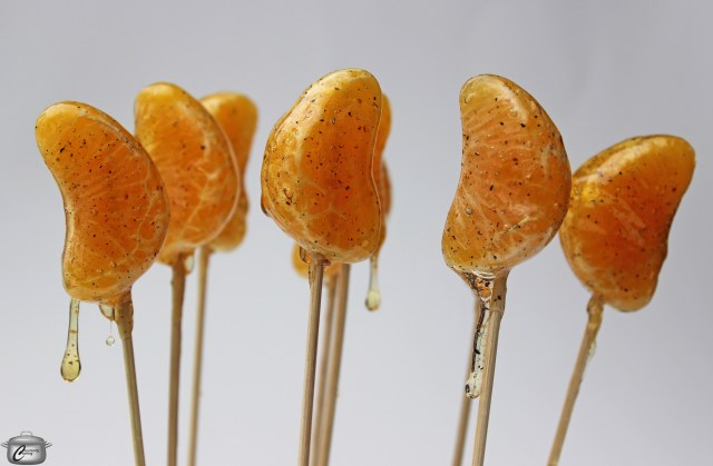 Cardamom-scented sugar syrup hardens beautifully on fresh fruit to create delicious lollipops. 