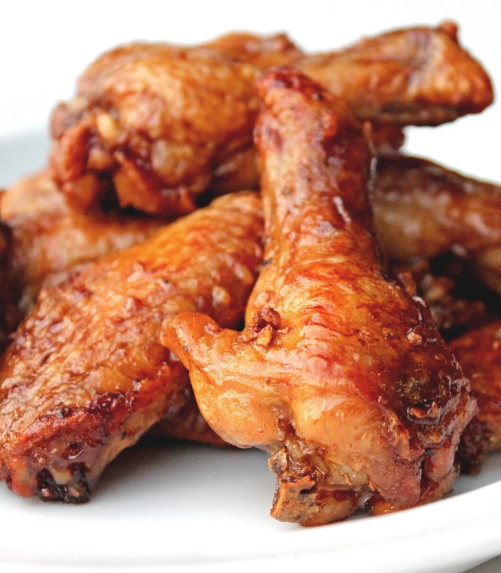 crispy oven-baked chicken wings coated in a spicy maple-sriracha sauce